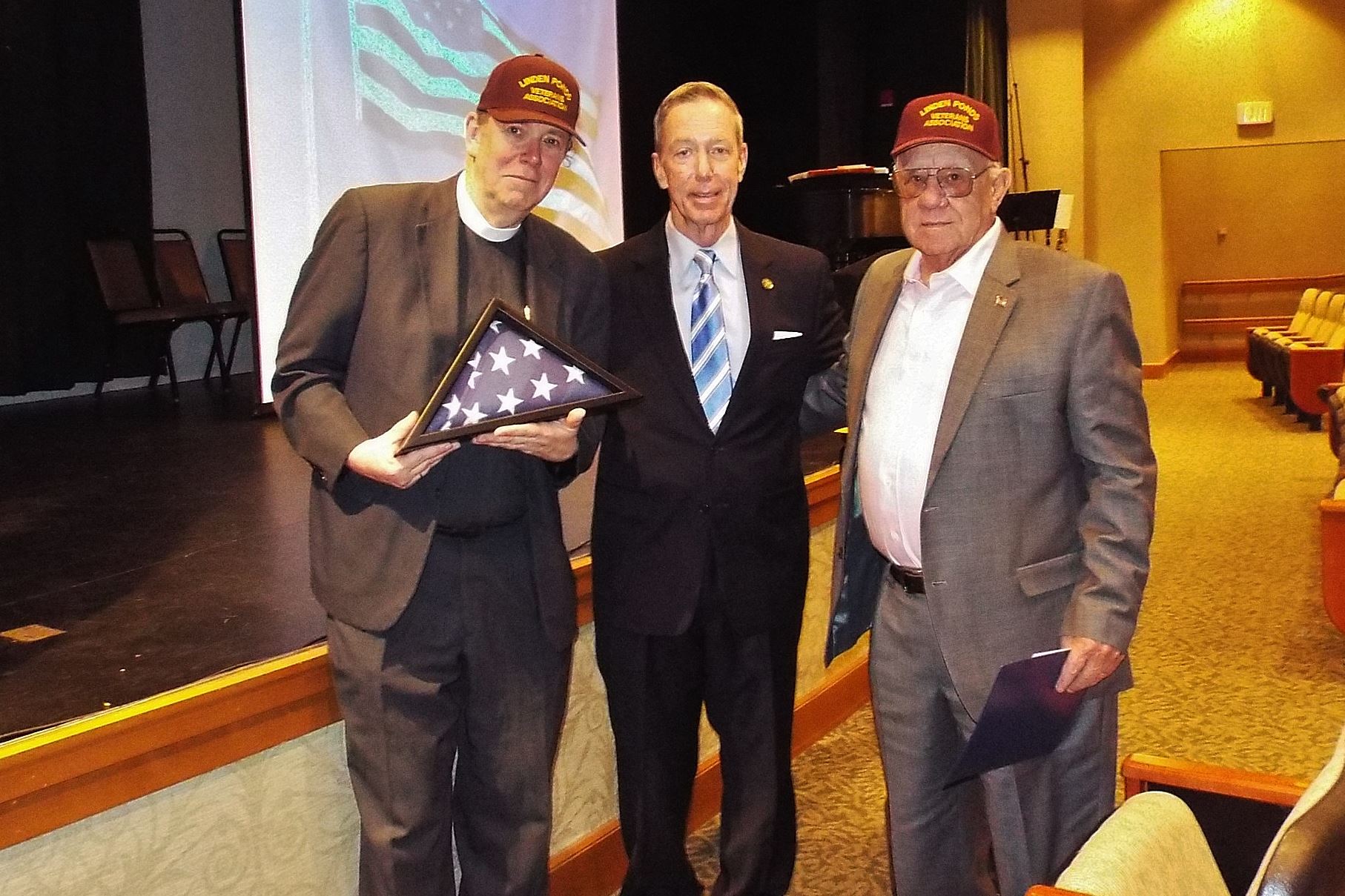 Pastoral Minister of LP and John Pinto-President of LP Veterans accept a flag flown over the Capital, Washington, DC from Congressman Stephen Lynch.